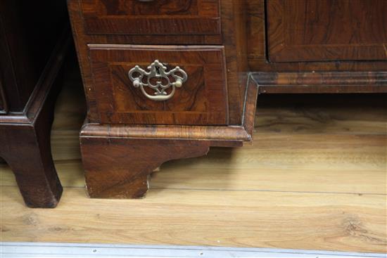 An early 18th century crossbanded kneehole desk, W.2ft 7in. D.1ft 7in. H.2ft 7in.